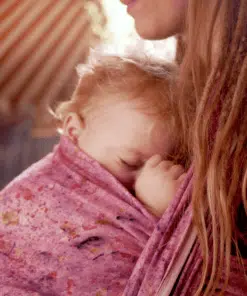 sleeping baby in a babywearing sling made of hemp